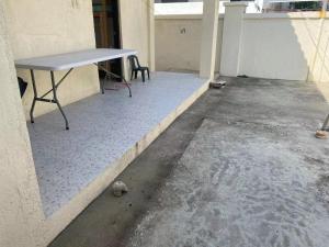 a table sitting on the floor of a building at Golden Kirins Beach Resort in Lian