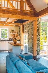 a blue couch in a living room with a table at Buitenliefde, romantisch verblijf voor 2 personen in Heiloo