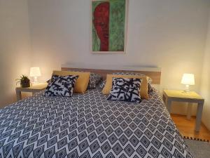a bedroom with a large bed with pillows at Apartments Dora in Crikvenica