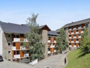 an exterior view of an apartment complex at Hébergement Coup de Coeur in Ax-les-Thermes