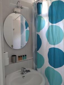 a bathroom with a sink and a mirror at Anastasia Studios & Apartments in Panormos Skopelos
