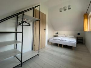 a bedroom with a bed and a spiral staircase at Chachatki Kopalino in Kopalino