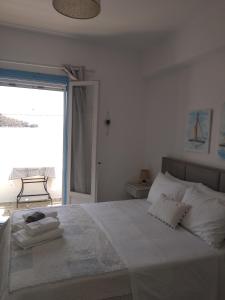 a bedroom with a large bed with towels on it at Anastasia Studios & Apartments in Panormos Skopelos