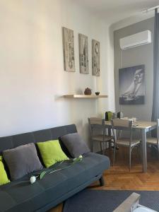 a living room with a couch and a dining table at Turul Apartment Budapest in Budapest