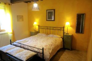 a bedroom with a bed and two night stands and two lamps at Antico Mulino in Monte Castelli