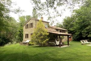 a large stone house with a gazebo in a yard at Antico Mulino in Monte Castelli