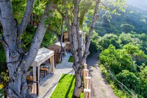 a view of a restaurant with tables and trees at DiliVita Rest House in Dilijan