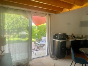 a kitchen with a sliding glass door to a patio at La Petite Chaunière in Saint-Fulgent