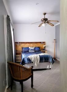 a bedroom with a bed and a ceiling fan at Greystoke - Furnished, self service apartment. in Springs