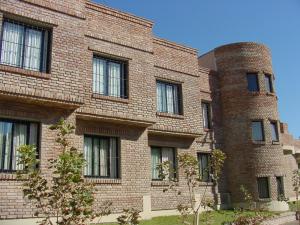 a brick building with windows on the side of it at Hotel Patagonia Norte in Las Grutas