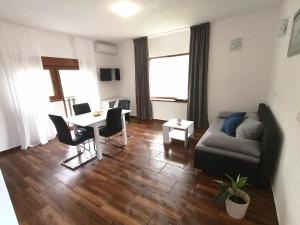 a living room with a couch and a table at Farma & Apartmani OPG Sasa Delic in Korenica