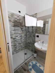 a bathroom with a shower and a sink at Valle dell'Eden in Grottammare