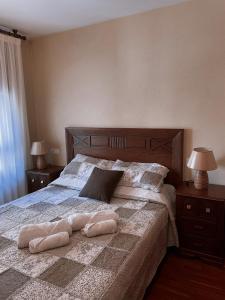 a bedroom with a large bed with two pillows on it at Camino al Cuera in Llanes