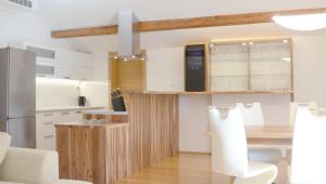 a kitchen with a table and a refrigerator at Apartma Tale in Kobarid