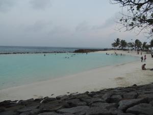 a group of people swimming in the water on a beach at Off Day Inn in Male City