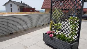 a planter with flowers in it next to a fence at Ferienwohnung Chattengau in Niedenstein