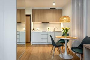 a kitchen and dining room with a table and chairs at InPoint Apartments G15 near Old Town & Kazimierz District & Optional Paid Parking in Krakow