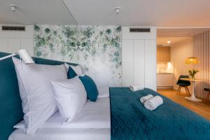 a bedroom with a bed with blue and white pillows at InPoint Apartments G15 near Old Town & Kazimierz District & Optional Paid Parking in Krakow +84 photos