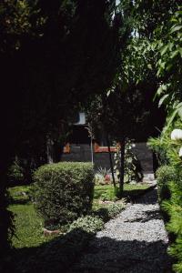 a garden with trees and a house in the background at House for rest Juliet in Velika Gorica