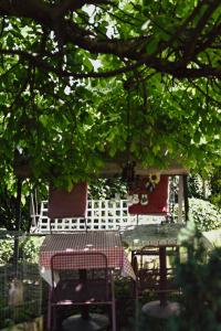 a table and two chairs sitting under a tree at House for rest Juliet in Velika Gorica