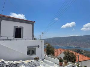 a white house with a view of the ocean at Traditional SeamansHouse Kochilos in Rogón