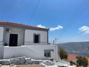 a white house with a view of the ocean at Traditional SeamansHouse Kochilos in Rogón