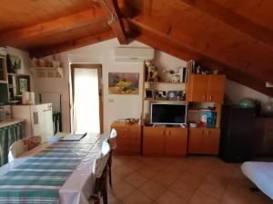 a kitchen with a table and a television in a room at La Calletta in Rovinj +36 photos
