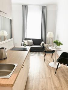 a living room with a couch and a table at Suites by Riga Old Town in Rīga