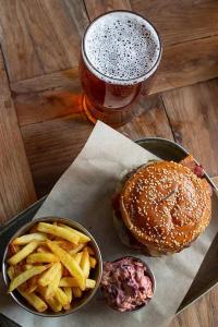 una hamburguesa y papas fritas en una mesa con una bebida en Carpenters Rest, Wighton Near Wells Next The Sea, en Wighton