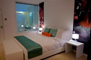 A bed or beds in a room at Vinyl M Hotel Design Inn