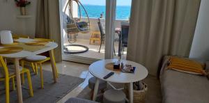 a living room with two tables and a view of the ocean at Apartment Vir in Vir