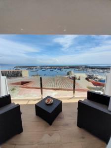 a room with a view of a marina with a table at Apartamento vista al puerto de Finisterre II in Fisterra