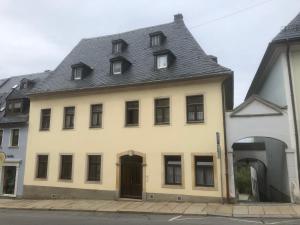 a white building with a gray roof at Wolke 33 in Annaberg-Buchholz