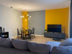 a living room with a couch and a dining room at Moderne & schöne Apartments zwischen Altstadt und Stadtpark in Nürnberg