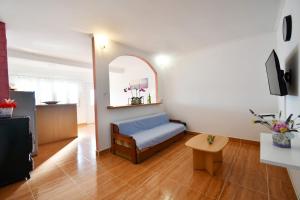 a small room with a bed and a table in it at Apartman Krstaš- Gonar in Supetarska Draga