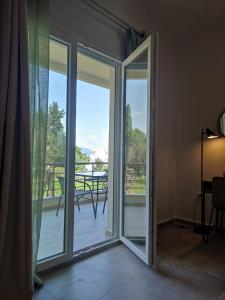 a sliding glass door with a view of a patio at Coritos apartments Corfu in Kontokali