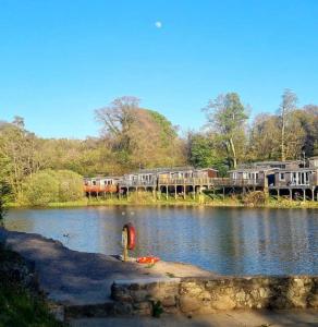 a bridge over a body of water with houses on it at MOEL SIABOD - GLAN GWNA HOLIDAY PARK in Caernarfon