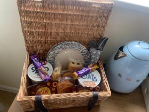 a basket filled with food and snacks next to a blender at Counting Sheep in Great Longstone