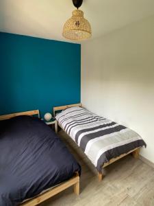 A bed or beds in a room at Les terrasses de la Baule