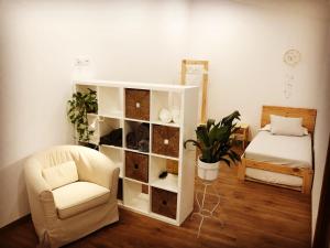 a bedroom with a white book shelf and a chair at Can Marlot in Navata