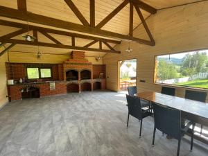 a large room with a fireplace and a table and chairs at Cabana Todireni Vatra Dornei in Vatra Dornei