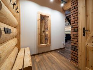 a room with a wooden wall and a wooden bench at Chata Czego Dusza Pragnie in Zachełmie