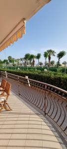 a patio with a bench and an umbrella at PraiadAmare in Praia a Mare