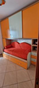 a bed with red pillows on it in a room at PraiadAmare in Praia a Mare