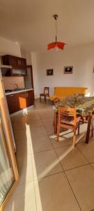 a living room with a table and a kitchen at PraiadAmare in Praia a Mare