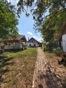 a brick path in front of a house at Róka's- Farm in Šupljak