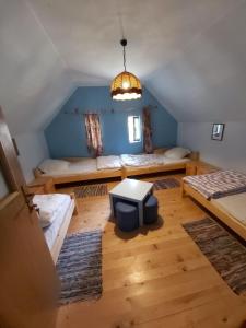 a room with two beds and a tv in it at Róka's- Farm in Šupljak