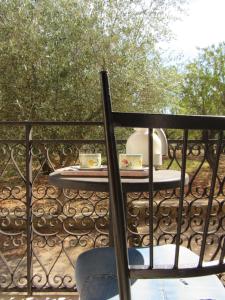 a table on a balcony with two cups of tea at Casa il Giovane Alloro in Martina Franca