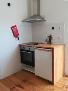 a kitchen with a stove and a counter top at Casa do Cristo Rei in Almada