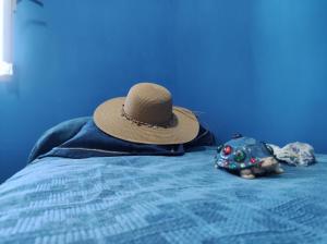 a hat on top of a bed with a toy at Le DueLamie in Sessa Cilento